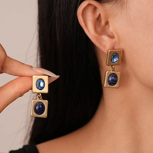 Vintage gold square earrings with dark blue resin gemstones in a minimalist geometric style