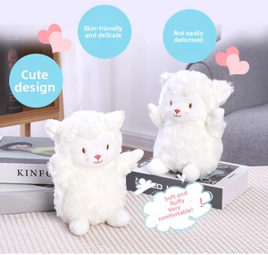 Close-up of soft white lamb plush toys with cute pink blush in a cozy home setting