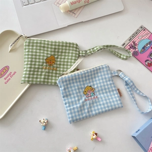 Detail of cute embroidered checkerboard canvas pouches for coins and small items