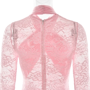Close-up of pink lace bodysuit featuring floral mesh texture and hidden back zipper