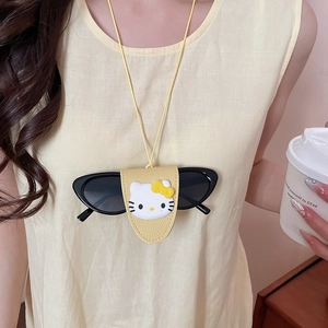 Close-up of a yellow leather cat-themed sunglasses holder worn as a necklace