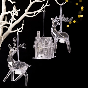 Light-up Christmas acrylic ornaments with reindeer and house shapes on white branch