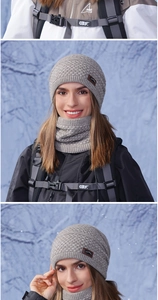 Close-up detail of grey winter knit hat and neck gaiter with thick cable stitch texture