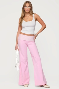 Detail of pink wide-leg pants featuring a stylish pink and white striped fold-over waistband
