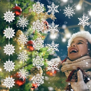 White Christmas snowflake ornaments hanging on a decorated tree with a smiling young girl