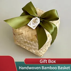 Handcrafted square bamboo gift box with olive green ribbon bow and gold tag detail