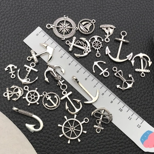 20pcs silver alloy nautical charms with anchors and wheels on textured background