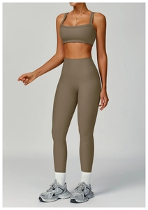 Detail of high-waisted ribbed yoga leggings and matching sports bra in taupe brown