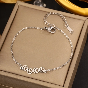 Detailed shot of silver paw print bracelet with lobster clasp on satin jewelry box