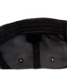 Detail of grey cotton baseball cap interior showing stitching and 100% cotton label