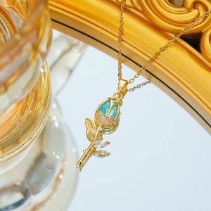 Macro shot of tulip flower necklace with blue teardrop crystal and gold chain