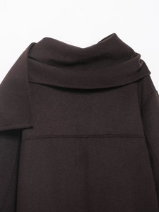 Macro view of the dark brown wool blend coat featuring a layered lapel and shoulder tailoring