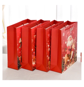 Set of four red Christmas gift bags featuring Santa, reindeer and gingerbread patterns