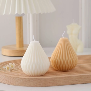 Macro detail of geometric teardrop scented candles in beige and light brown wax