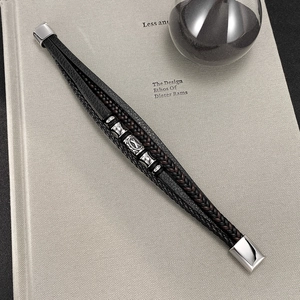 Detail of multi-layer braided leather bracelet for men featuring silver metallic beads
