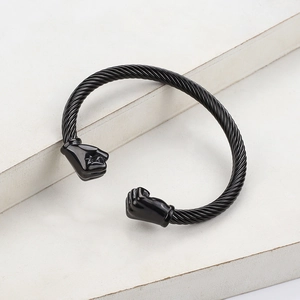 Men's black stainless steel cable twist bracelet with fist-shaped ends on stone