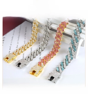 Detailed close-up of 13.8mm iced out Cuban link chains in gold, silver, pink and blue colors
