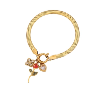 Golden snake chain bracelet with red rose, zircon heart, and clover charms on white background