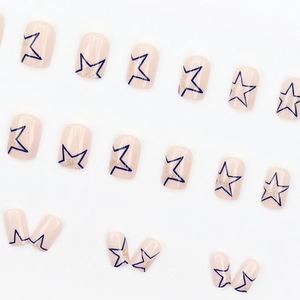 Square nude pink press-on nails with blue stars and silver glitter shimmer detailing
