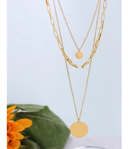 Detail of three-layer gold titanium steel necklace with paperclip chain and round discs