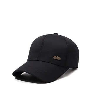 Detail shot of black baseball cap with bronze mountain emblem and curved brim stitching