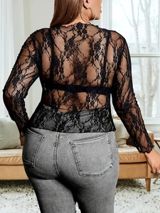 Back view of black floral lace sheer top with long sleeves paired with gray jeans