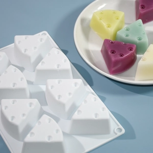 Detail view of 8-cavity triangle cheese silicone mold with realistic texture and samples