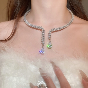 Detail of a sparkling teardrop zircon pendant on a silver-tone double row choker necklace