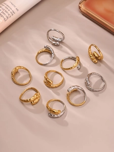 Detail view of irregular hammered gold and silver stacking rings with wrap design