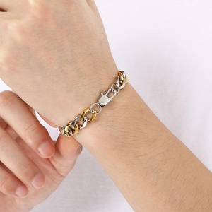 Men's 9mm two-tone gold and silver stainless steel link bracelet on a male wrist