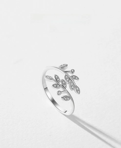 Macro detail of leaf-shaped S925 sterling silver ring with shimmering pavé diamonds
