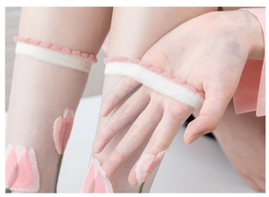 Close-up of ultra-thin sheer socks featuring tulip floral patterns and ruffled elastic cuffs