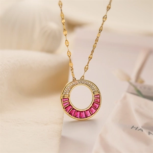 Macro shot of gold plated necklace with pink square gemstone and white zircon stones