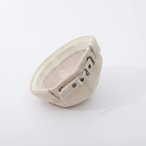 Detail view of beige corduroy baby docker hat with metal buckle and adjustable strap