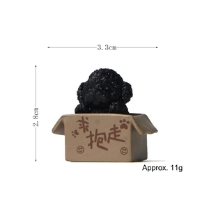 Detailed view of a miniature black poodle figurine in a small box with size markings