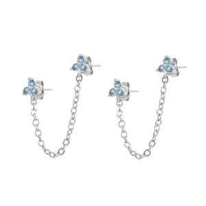 Macro detail of silver floral chain earrings with light blue cubic zirconia stones