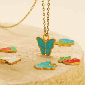 Close-up of a turquoise enamel butterfly pendant on a gold stainless steel necklace