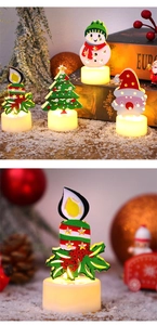 Close-up of LED Christmas candle lights featuring snowman and Santa Claus holiday designs