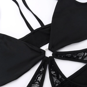 Detail of metal ring connector on a sexy black lace halter bodysuit with hollow design