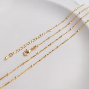 Macro shot of 14K gold filled satellite chain with lobster clasp and 14KGF hallmark