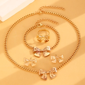 Elegant gold bow jewelry set featuring a necklace, bracelet, earrings, and ring for women