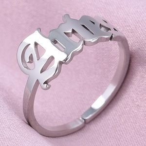 Macro shot of silver Aries zodiac ring with Old English font and adjustable open band