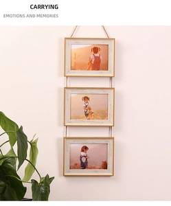 Detail of triple hanging wooden photo frame with natural jute rope on a clean wall