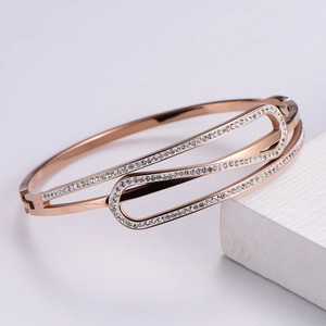 Close-up of interlocking rose gold oval cuff with pavé sparkling zircon stones