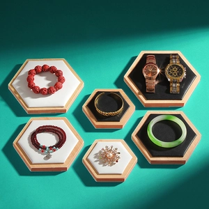 Hexagonal bamboo wooden jewelry display trays with black velvet and white leather inserts