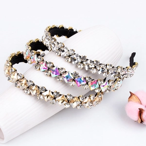 Luxe rhinestone headband set with crystal embellishments on elegant ceramic display