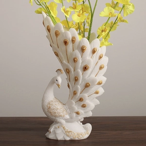 Elegant white peacock flower vase with gold details and yellow flowers for home decor