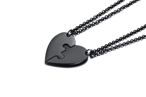 Detail of black heart-shaped puzzle pendant necklace set for couples or friends