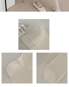 Detail view of cream white ribbed crew socks showing toe seams and knit texture