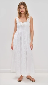 Detailed close-up of white lace dress featuring 3D floral embroidery and strap detail